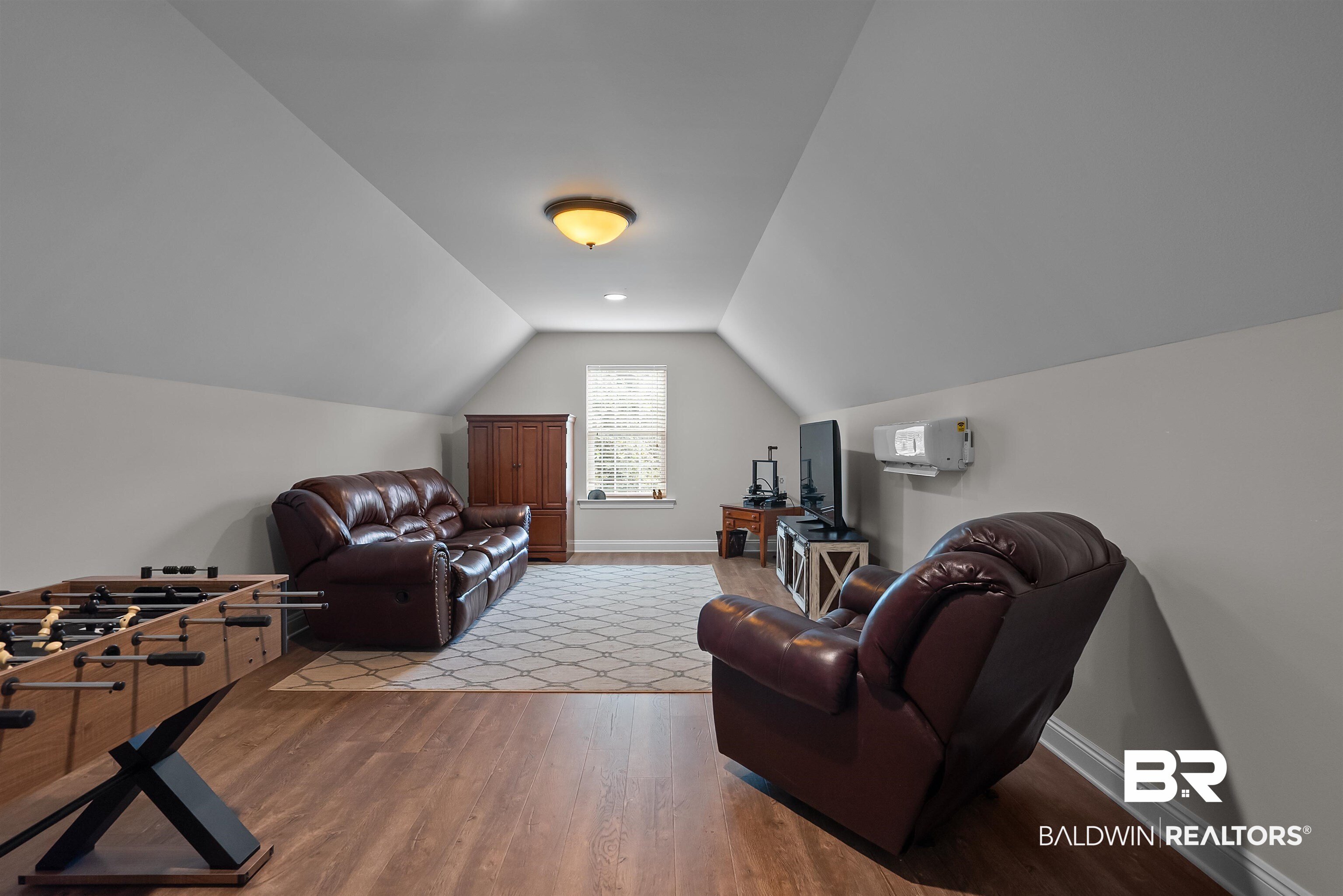 12070 Comalander Road Fairhope, AL 36532 - Photo 38 of 50 Spacious room featuring sloped ceilings, recessed lighting, wood-finish flooring, a wall-mounted mini-split system, and a window with white trim