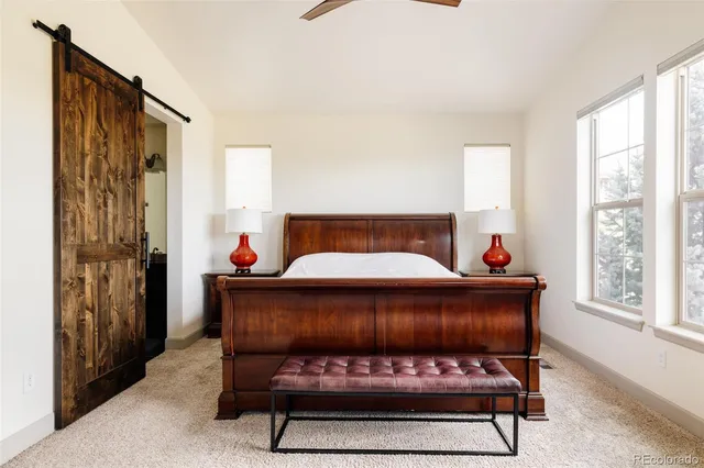 a bed sitting in a bedroom next to a window