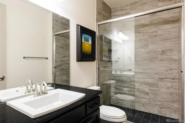 a bathroom with a sink toilet and shower