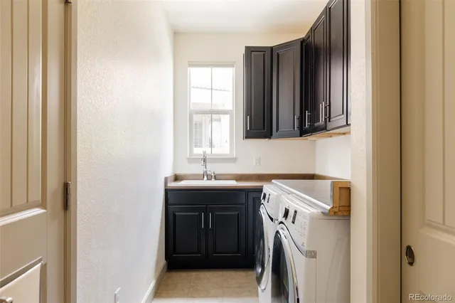 a utility room with a sink a washer and dryer