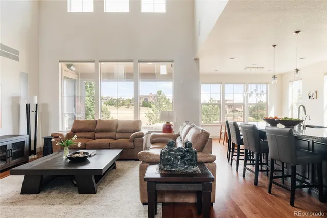 a living room with furniture and floor to ceiling windows