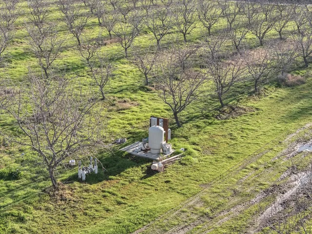an aerial view of a yard with an outdoor space and seating
