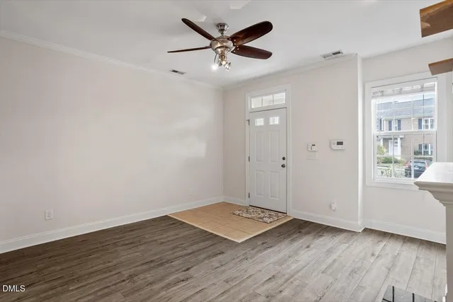 wooden floor in an empty room with a window