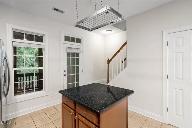 a kitchen with a sink a counter space and cabinets