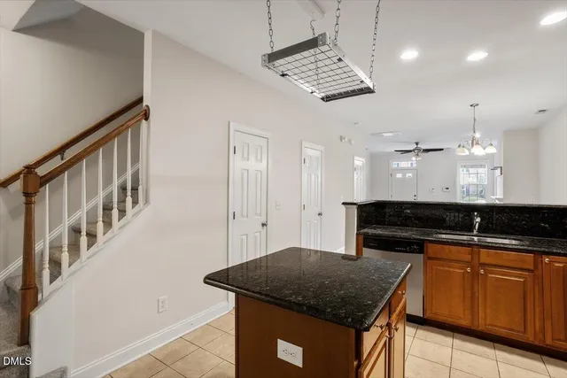 a kitchen with a sink a counter space cabinets and appliances