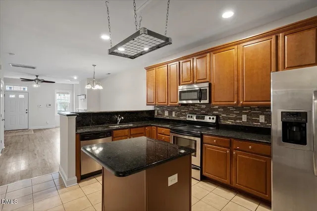 a stove top oven sitting inside of a kitchen