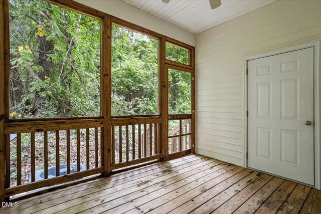 a view of balcony with wooden floor and fence