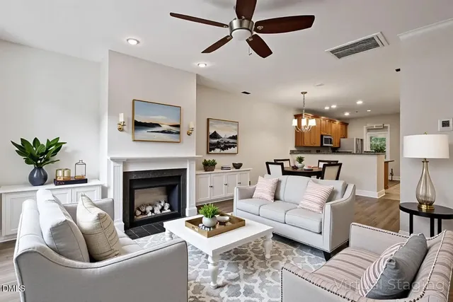 a living room with furniture a fireplace and a flat screen tv