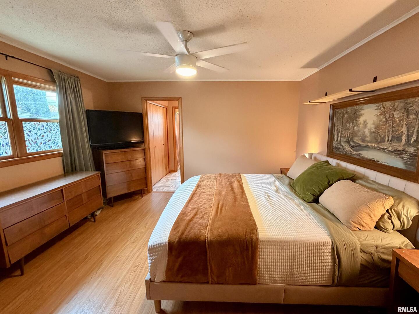 1043 14th Avenue South Clinton, IA 52732 - Photo 14 of 23 a bedroom with a bed and wooden floor