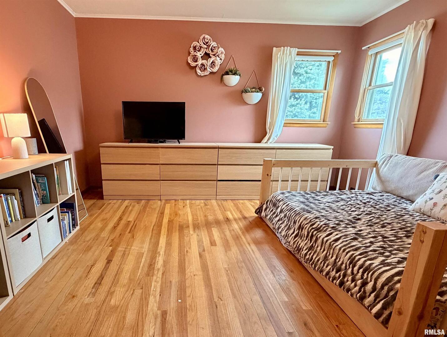 1043 14th Avenue South Clinton, IA 52732 - Photo 17 of 23 a bedroom with a bed and a bookshelf