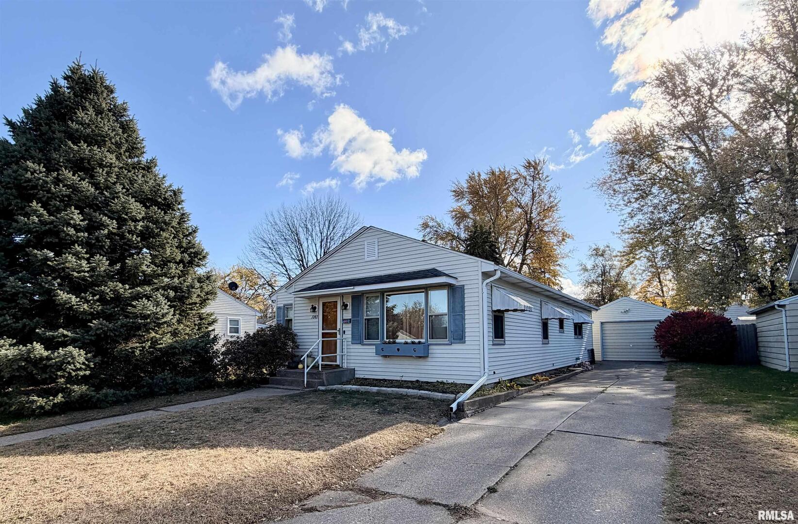 1043 14th Avenue South Clinton, IA 52732 - Photo 2 of 23 a front view of a house with a yard
