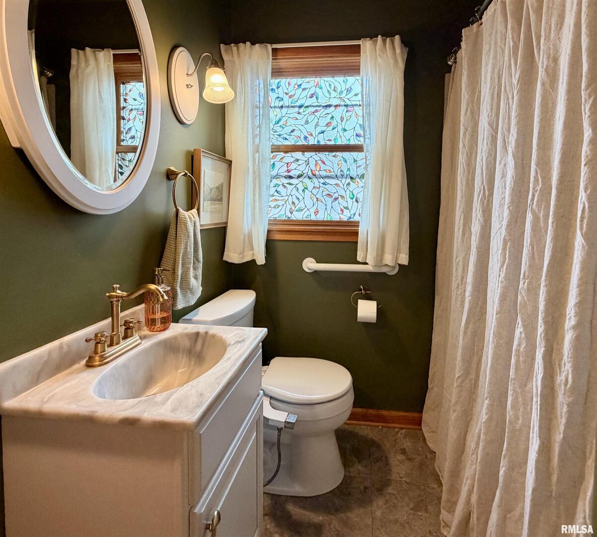 1043 14th Avenue South Clinton, IA 52732 - Photo 21 of 23 a bathroom with a toilet and a sink