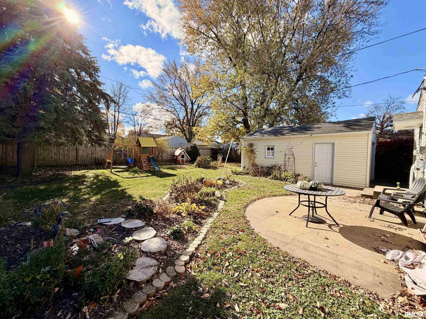 1043 14th Avenue South Clinton, IA 52732 - Photo 3 of 23 a view of a backyard with table and chairs with a patio and a fire pit