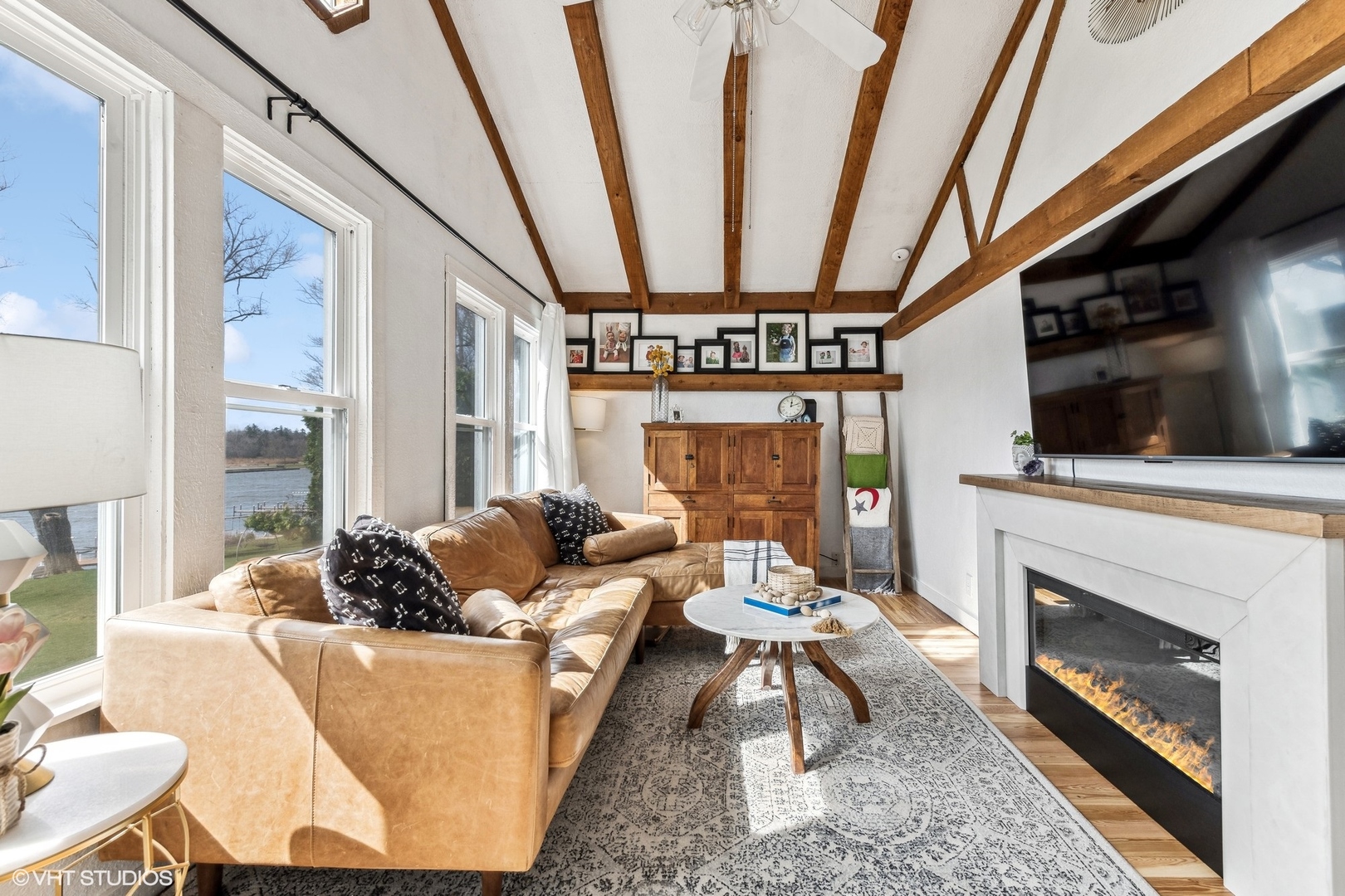 705 Spring Beach Way Cary, IL 60013 - Photo 13 of 47 a living room with furniture a flat screen tv and a fireplace