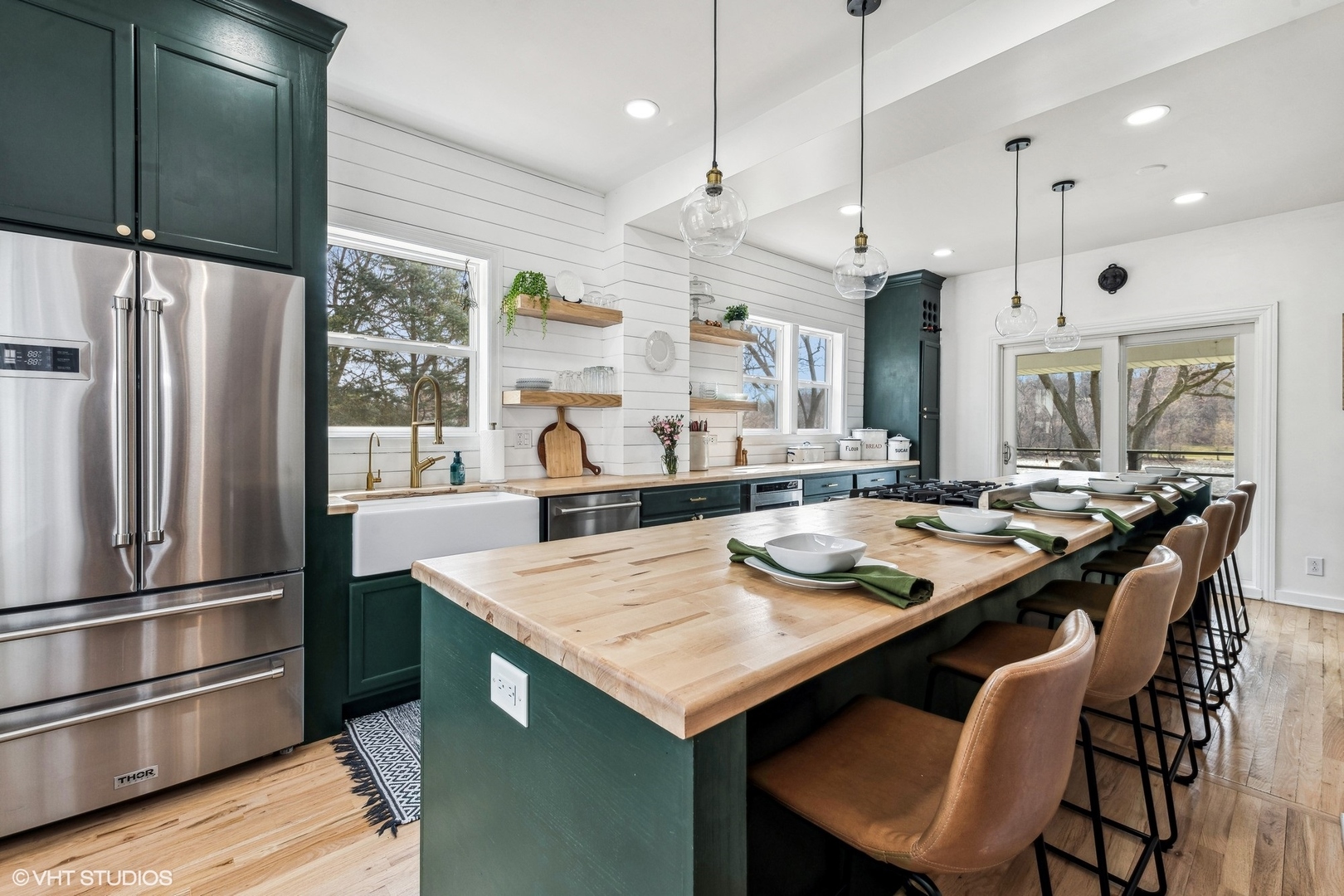 705 Spring Beach Way Cary, IL 60013 - Photo 6 of 47 a kitchen with stainless steel appliances granite countertop a table chairs and a refrigerator