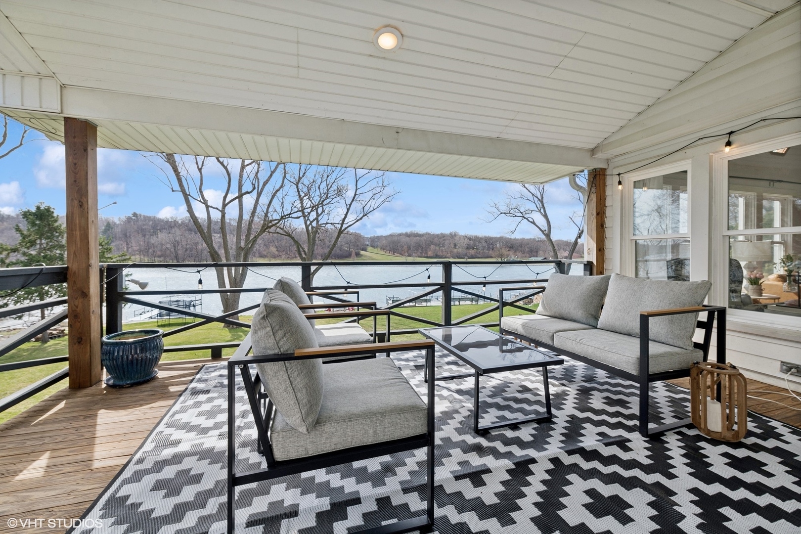 705 Spring Beach Way Cary, IL 60013 - Photo 7 of 47 a balcony with chairs and table with wooden floor
