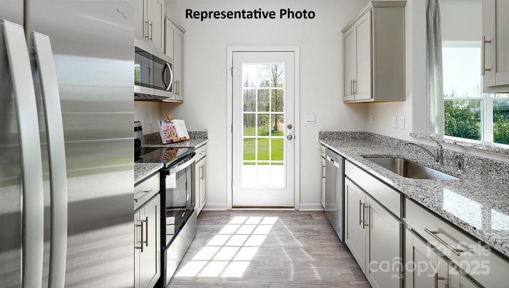 1314 Equestrian Lane York, SC 29745 - Photo 7 of 25 a kitchen with a sink a refrigerator and window