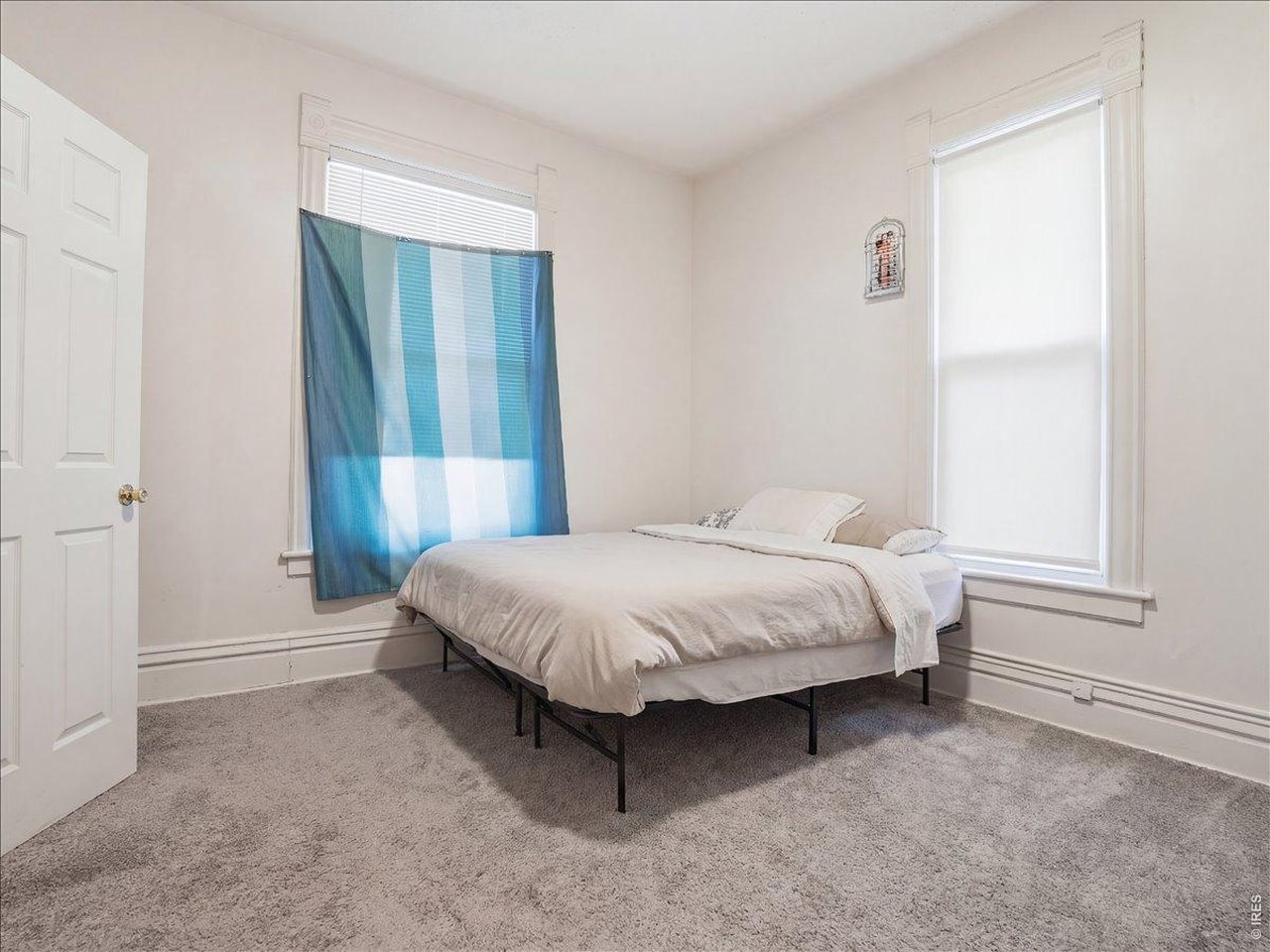 228 13th Street Greeley, CO 80631 - Photo 18 of 29 a spacious bedroom with a bed and a window