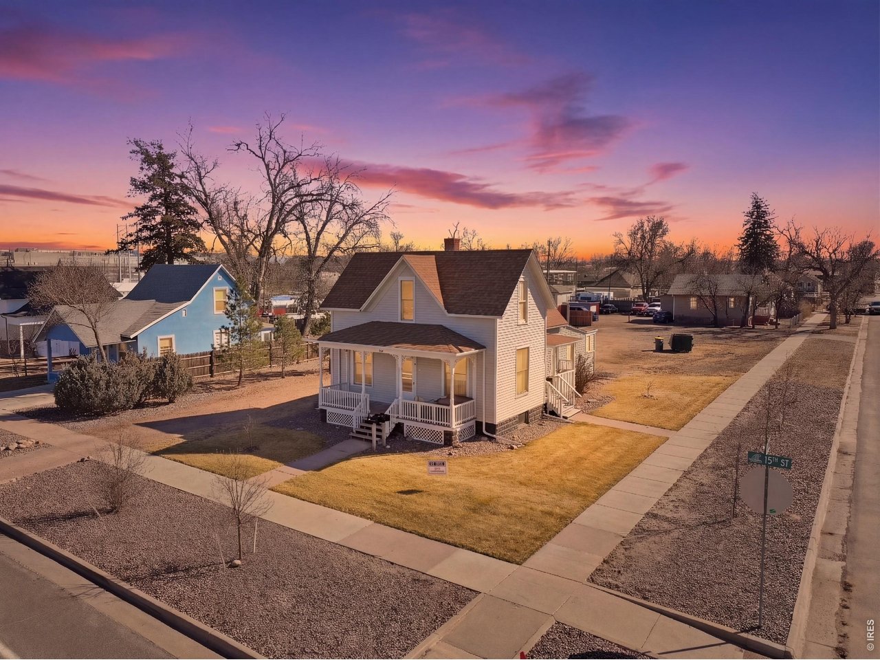 228 13th Street Greeley, CO 80631 - Photo 2 of 29 a view of a white house with a yard