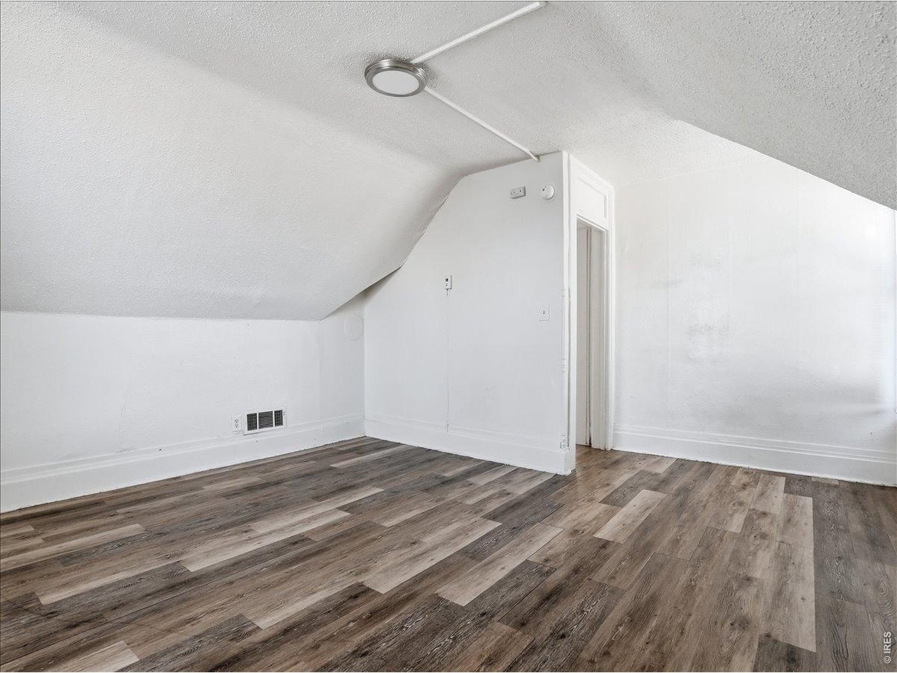 228 13th Street Greeley, CO 80631 - Photo 21 of 29 a view of an empty room with wooden floor