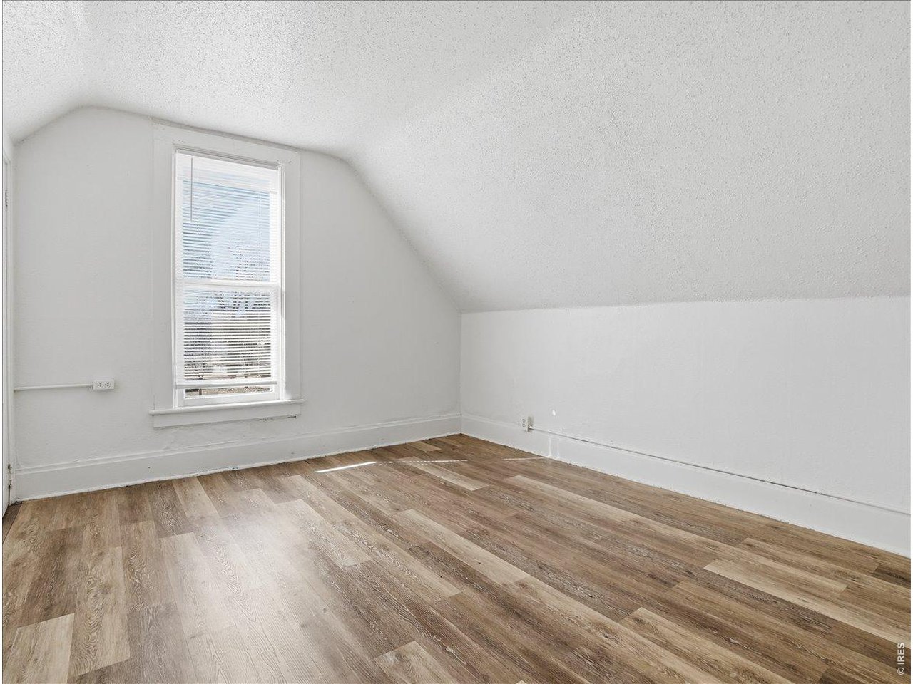 228 13th Street Greeley, CO 80631 - Photo 22 of 29 an empty room with wooden floor and windows