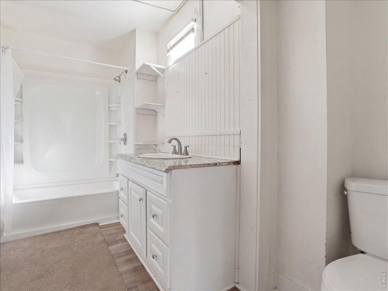 228 13th Street Greeley, CO 80631 - Photo 24 of 29 a bathroom with a granite countertop sink toilet and shower