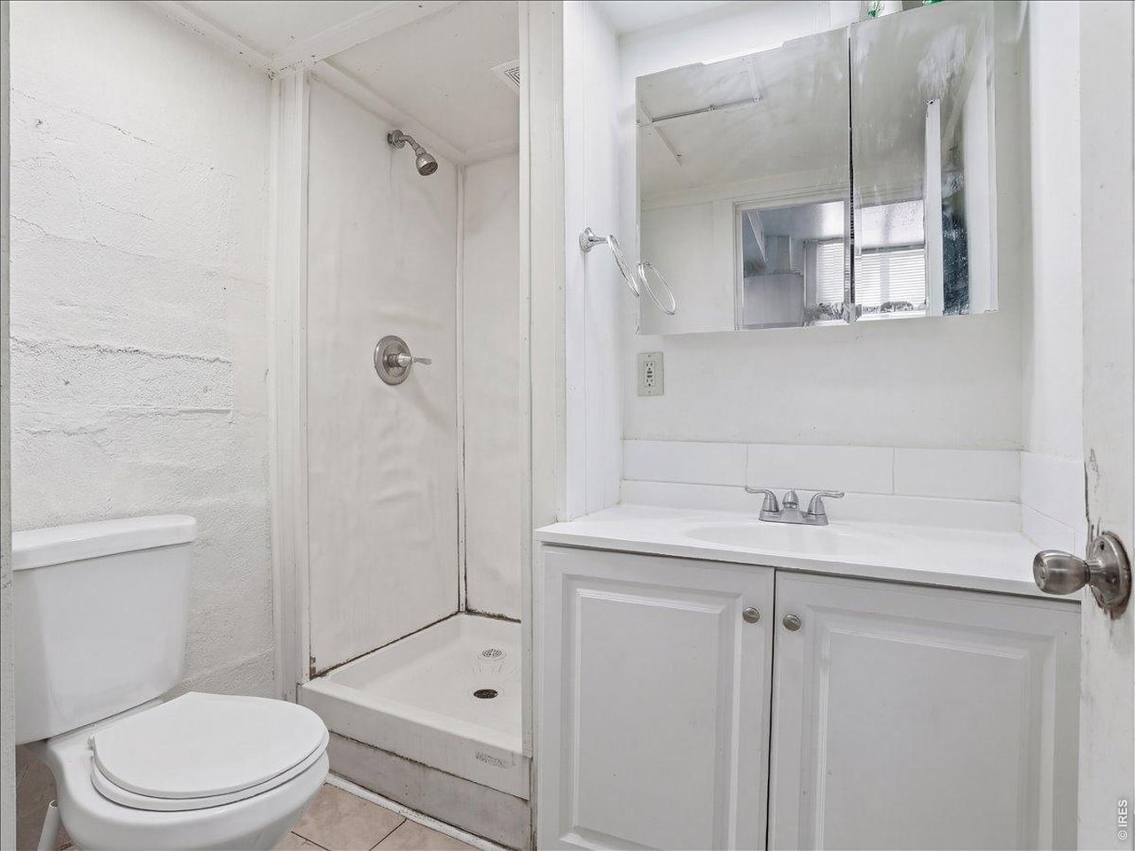 228 13th Street Greeley, CO 80631 - Photo 25 of 29 a bathroom with a sink a toilet and shower