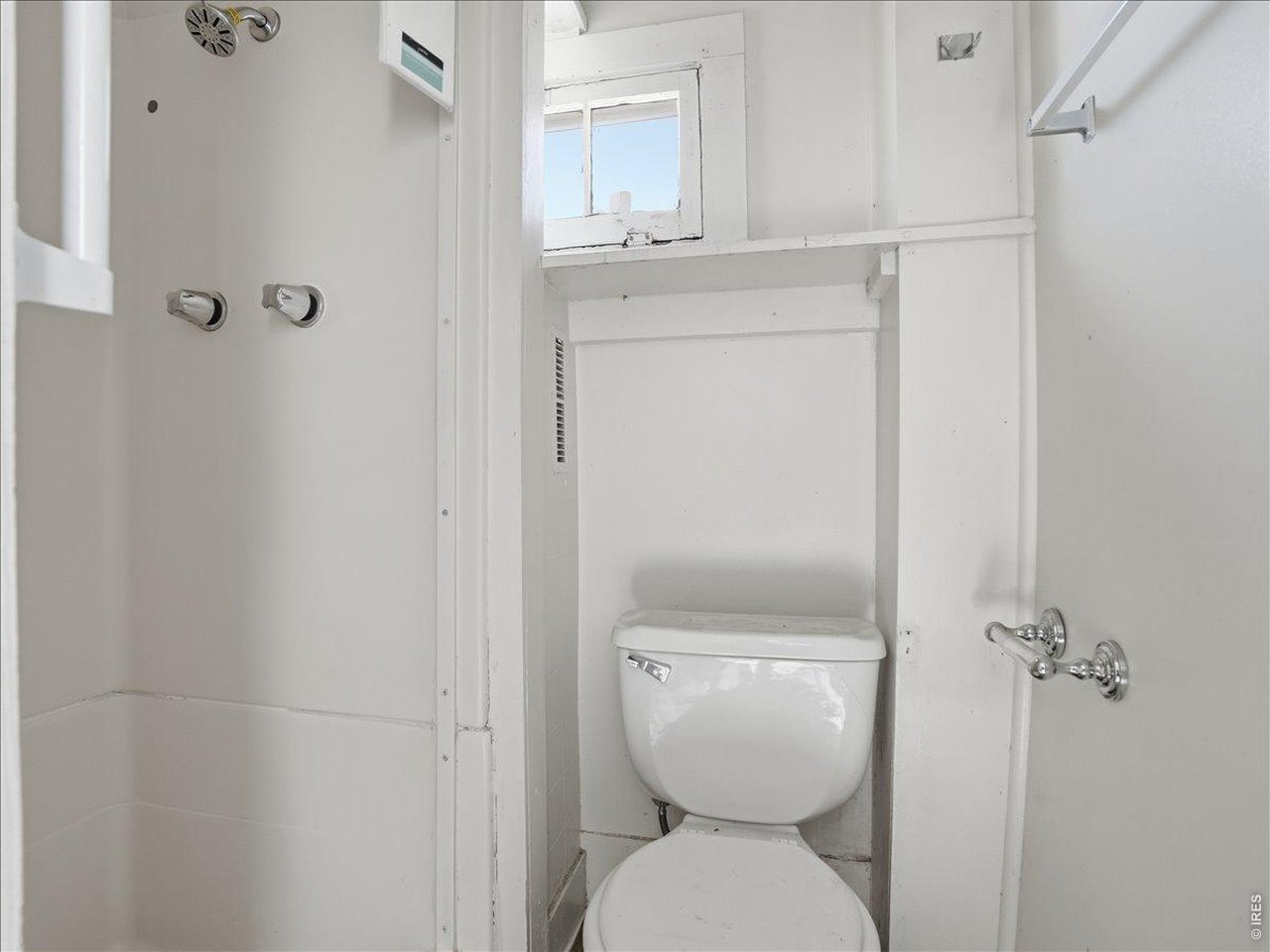228 13th Street Greeley, CO 80631 - Photo 26 of 29 a white toilet sitting next to a bathroom sink