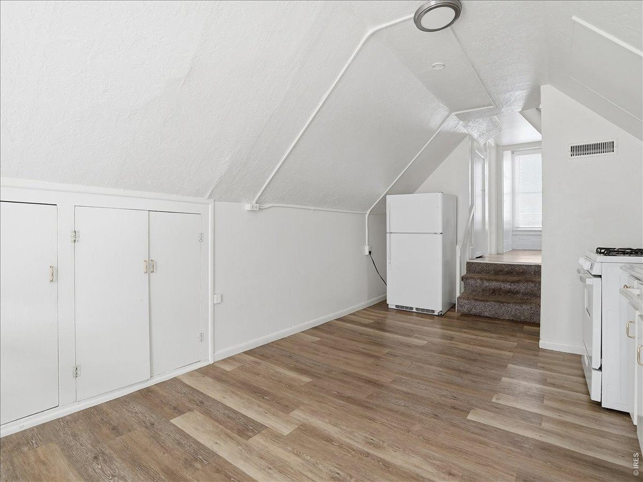 228 13th Street Greeley, CO 80631 - Photo 28 of 29 a view of empty room with wooden floor and fan
