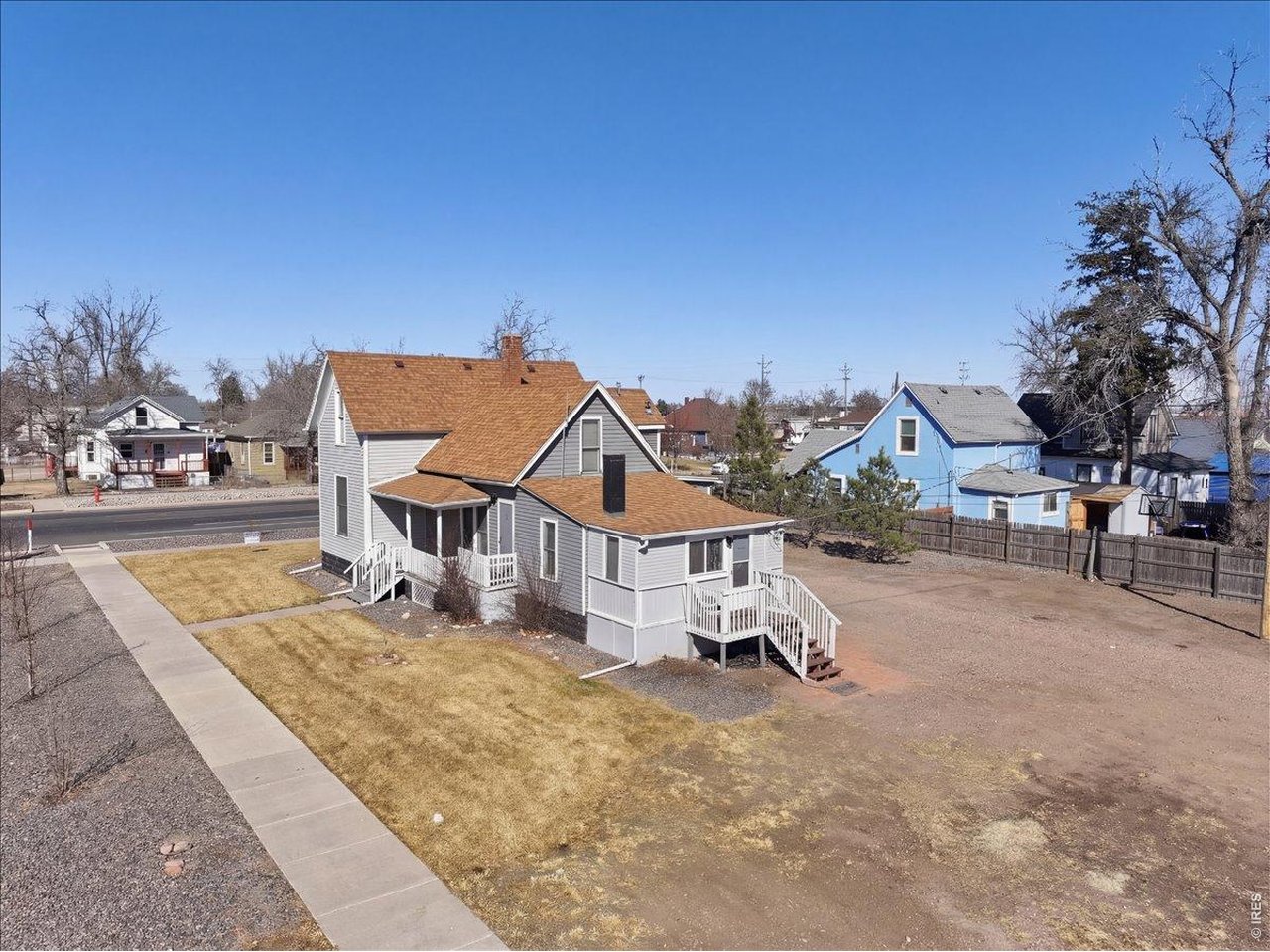 228 13th Street Greeley, CO 80631 - Photo 4 of 29 a white house that has a tree in front of it