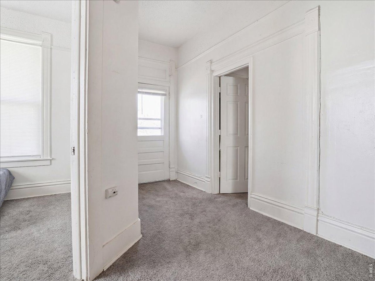 228 13th Street Greeley, CO 80631 - Photo 9 of 29 a view of an empty room with closet and a window