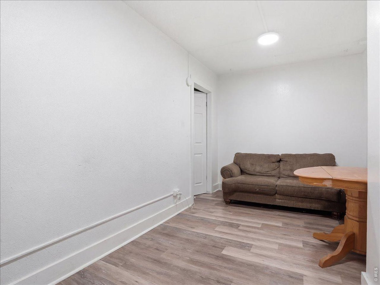 228 13th Street Greeley, CO 80631 - Photo 10 of 29 a living room with furniture and a wooden floor