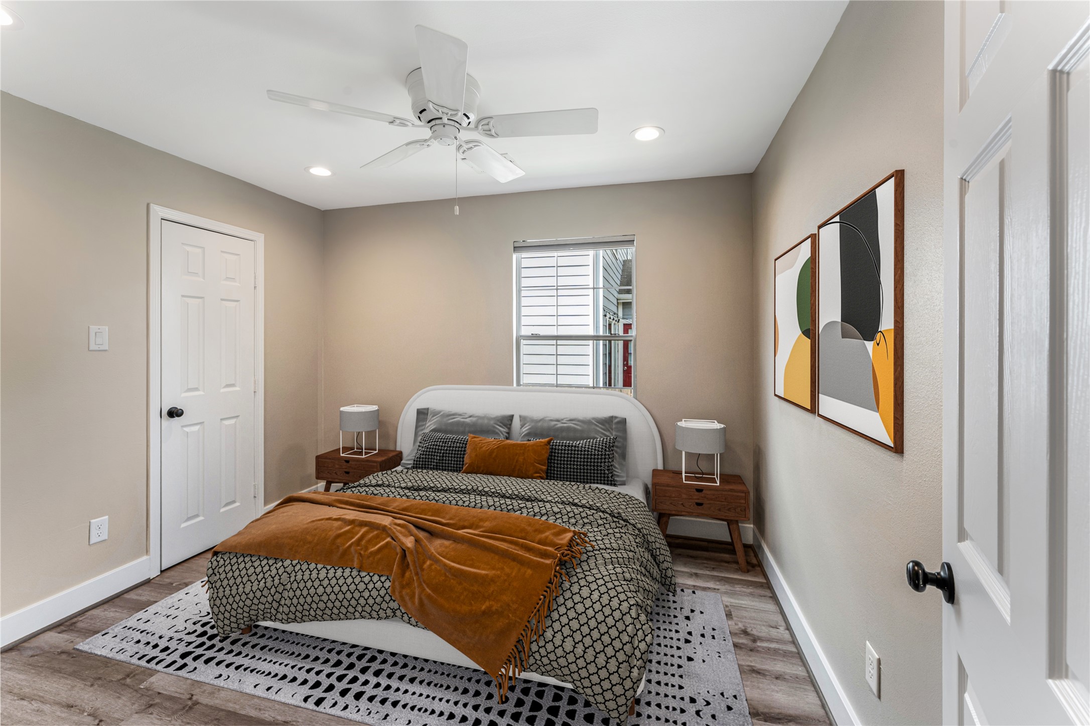 809 East 40th Street Houston, TX 77022 - Photo 23 of 27 Spacious bedroom with fresh neutral paint, new flooring, and updated ceiling fan creates a comfortable retreat. Natural light fills the room, enhancing the clean and modern aesthetic. virtually staged