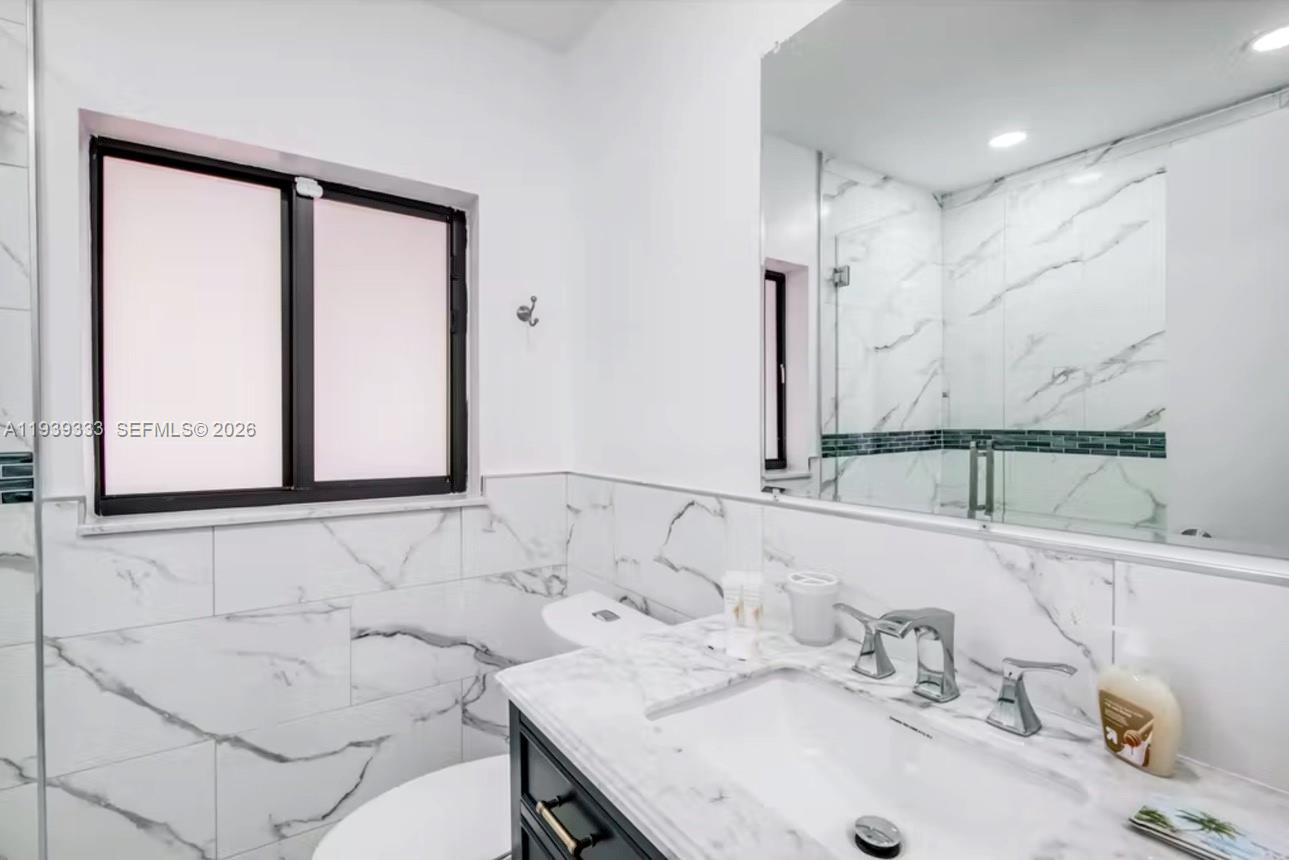 2639 Monroe Street Hollywood, FL 33020 - Photo 15 of 27 a bathroom with a sink and a mirror