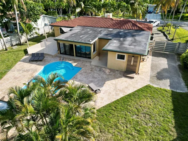 a view of a house with swimming pool and sitting area