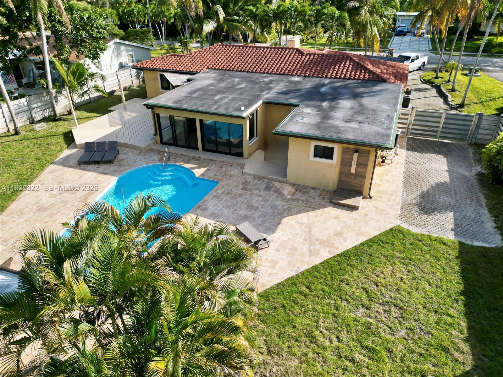 2639 Monroe Street Hollywood, FL 33020 - Photo 18 of 27 a view of a house with swimming pool and sitting area