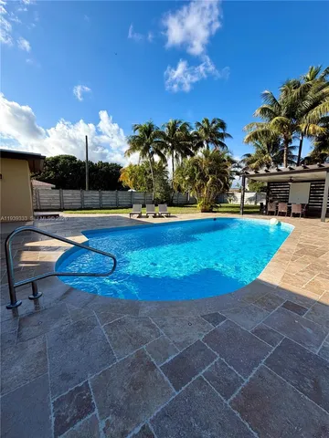 a view of a swimming pool with a yard