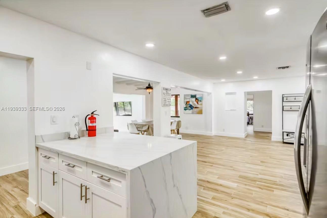 2639 Monroe Street Hollywood, FL 33020 - Photo 6 of 27 a view of a kitchen island a sink and wooden floor