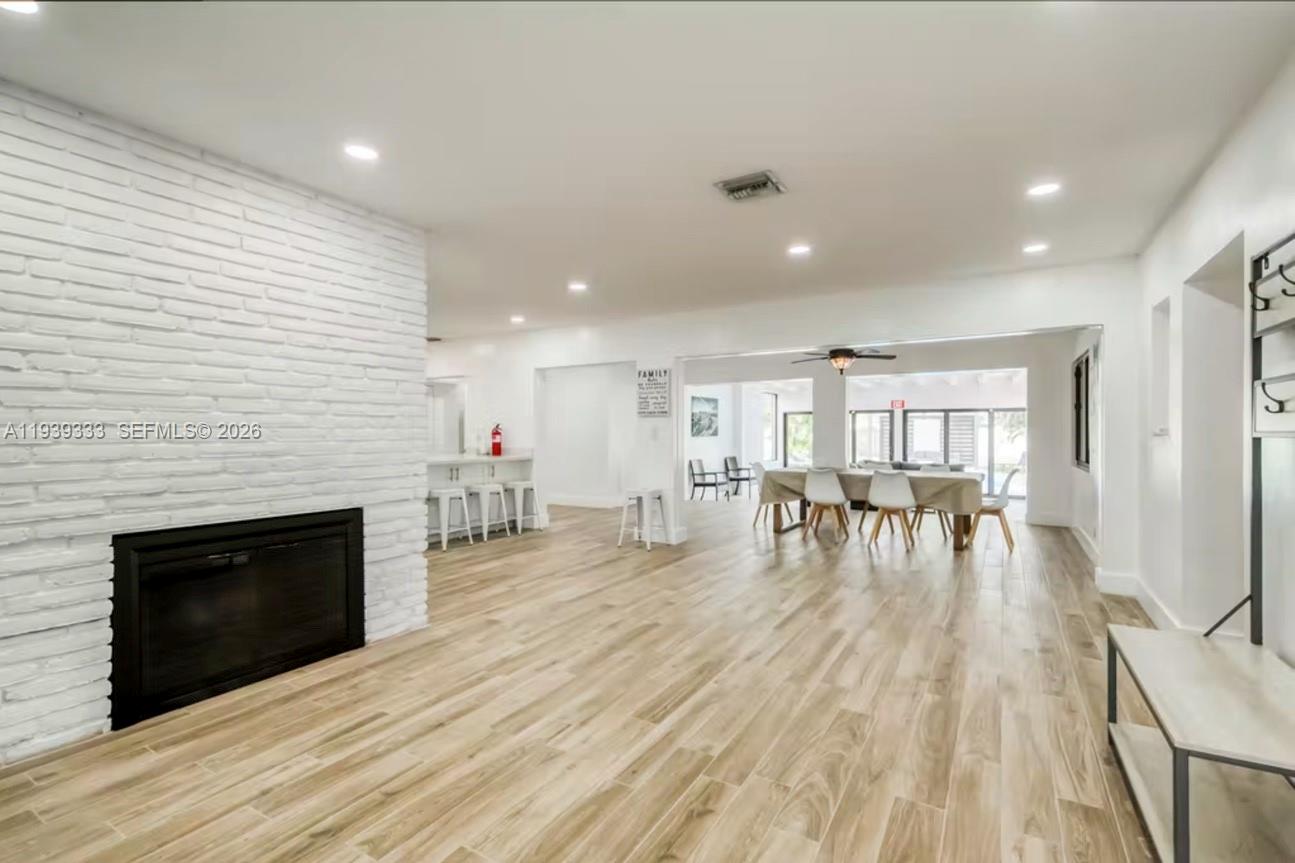 2639 Monroe Street Hollywood, FL 33020 - Photo 7 of 27 a living room with furniture and a fireplace