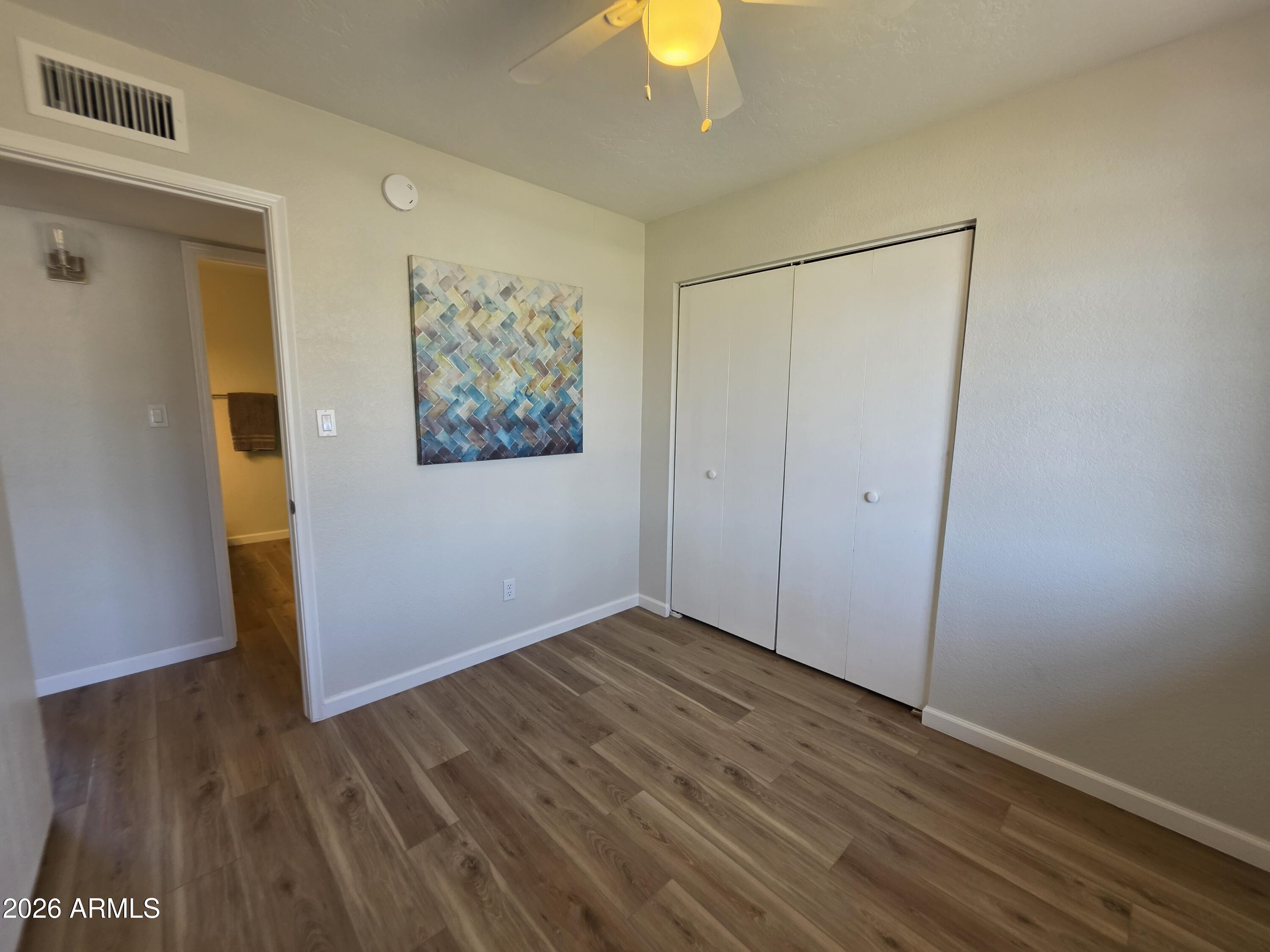 46 East McLellan Road Mesa, AZ 85201 - Photo 11 of 18 a view of room with wooden floor and fan