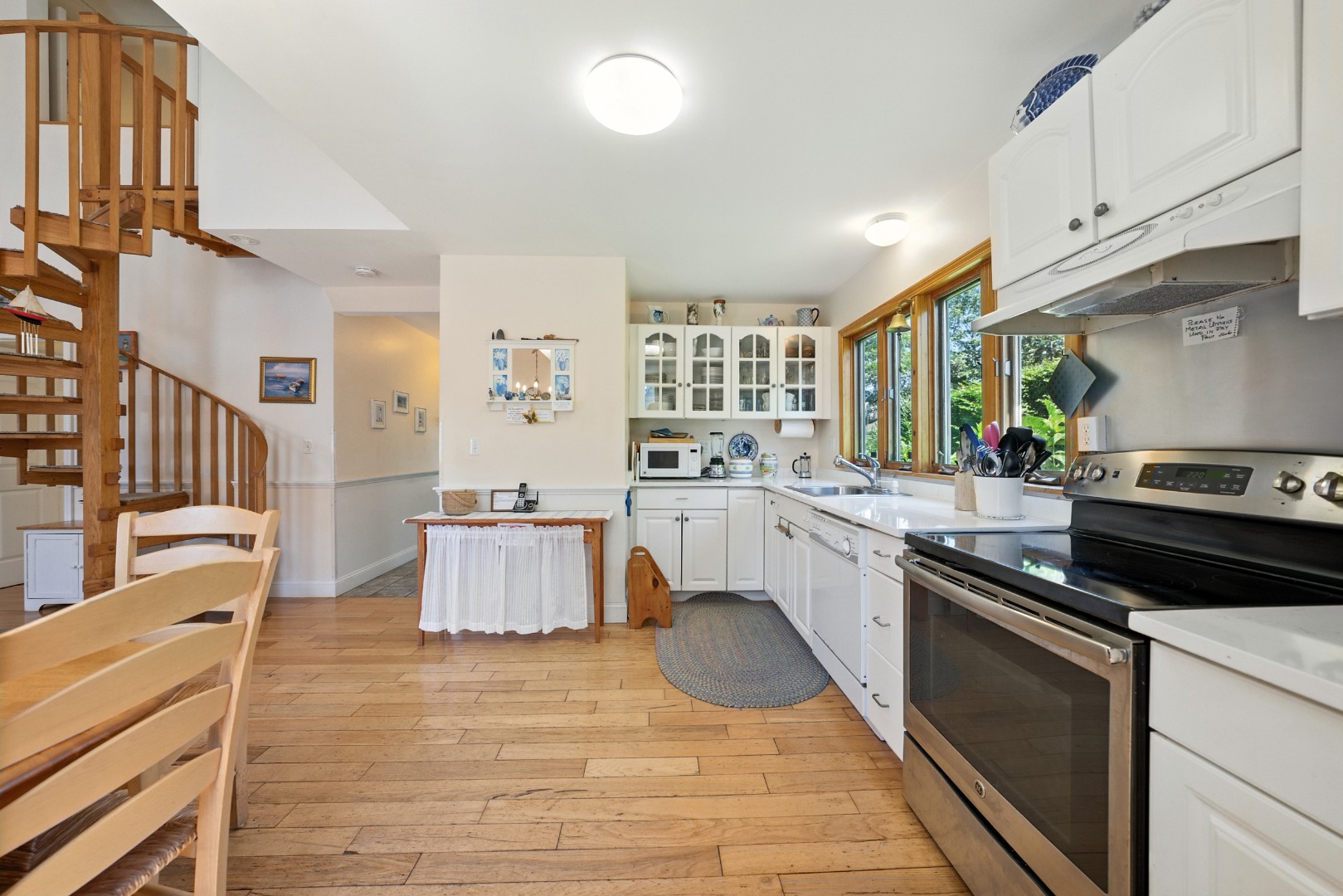 52 Pleasant Street Nantucket, MA 02554 - Photo 12 of 36 a kitchen with stainless steel appliances granite countertop a stove a sink and a refrigerator