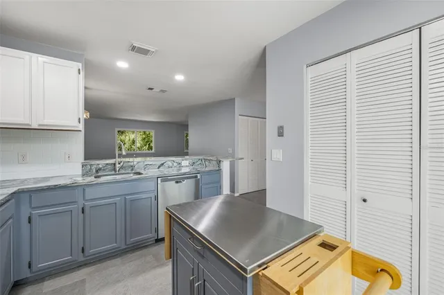 a kitchen with a sink stove and cabinets