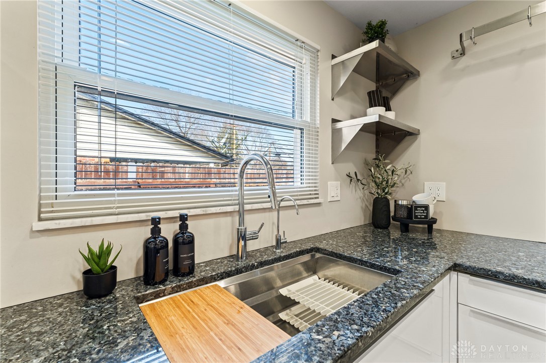 2247 East Whipp Road Dayton, OH 45440 - Photo 22 of 52 This modern kitchen features elegant countertops, a stainless steel sink, and sleek cabinetry.