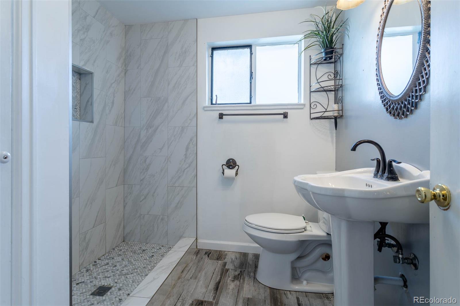 3075 South Emerson Way Englewood, CO 80113 - Photo 13 of 28 a bathroom with a sink toilet and a mirror