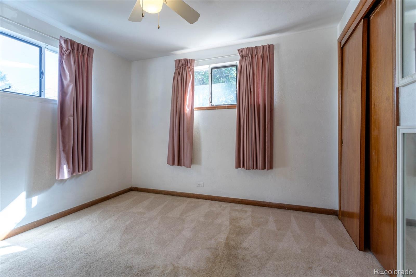 3075 South Emerson Way Englewood, CO 80113 - Photo 14 of 28 an empty room with windows and closet