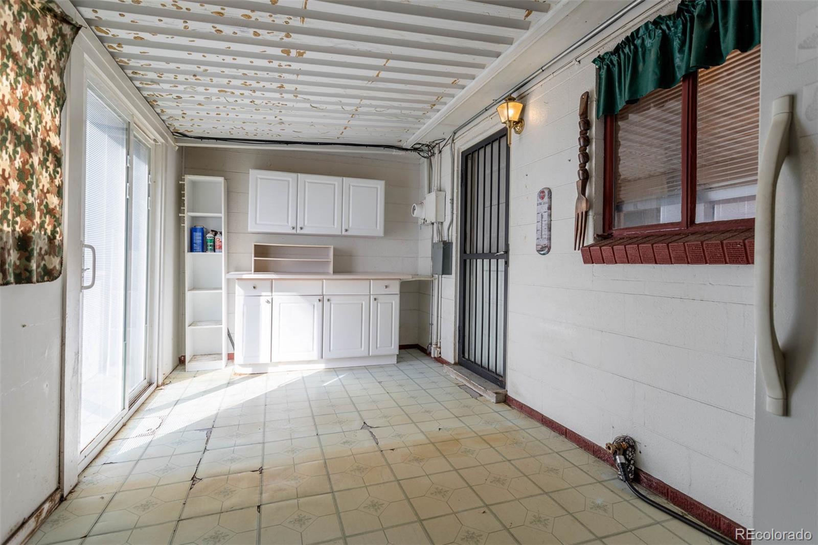 3075 South Emerson Way Englewood, CO 80113 - Photo 16 of 28 a view of a kitchen with wooden cabinet and a refrigerator