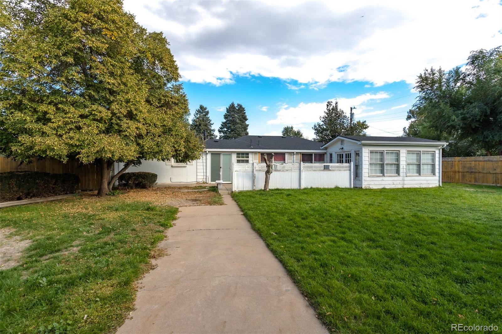 3075 South Emerson Way Englewood, CO 80113 - Photo 21 of 28 a view of a house with yard and a garden