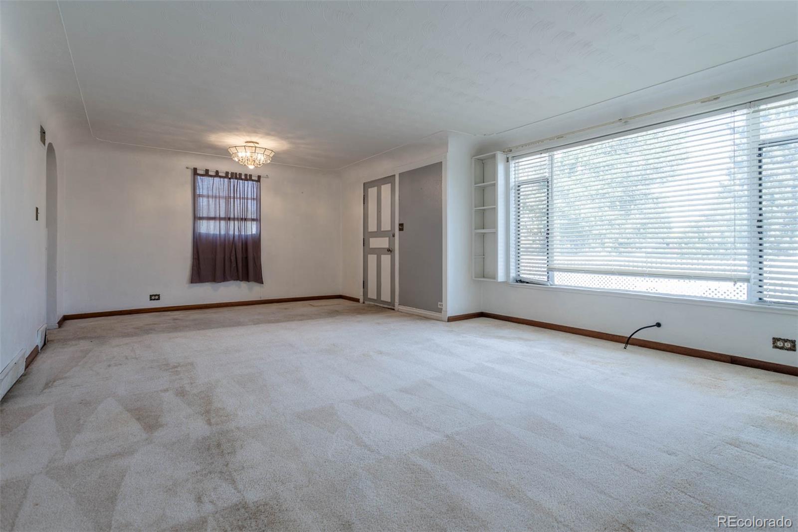 3075 South Emerson Way Englewood, CO 80113 - Photo 4 of 28 a view of an empty room with a window