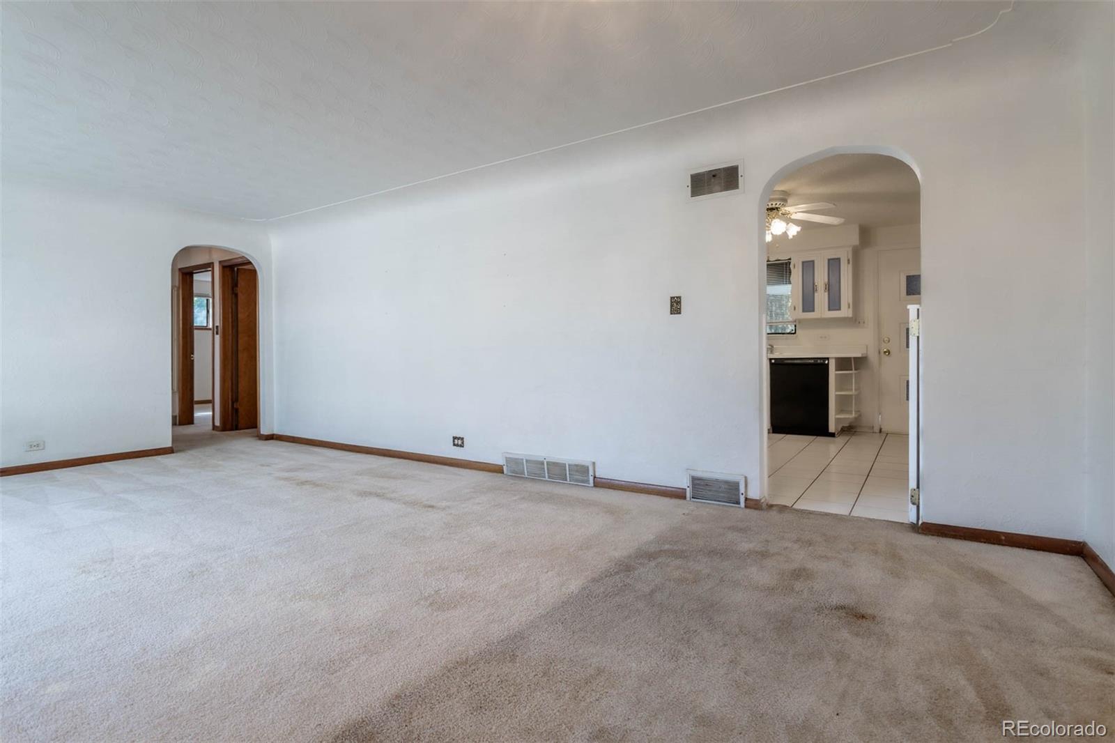 3075 South Emerson Way Englewood, CO 80113 - Photo 6 of 28 a view of a livingroom with wooden floor and kitchen view
