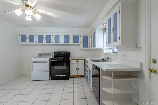 a kitchen with a stove sink and cabinets